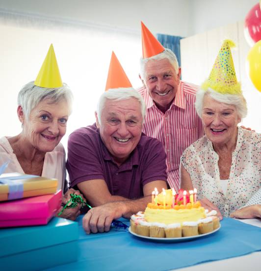 A group of seniors celebrating their friend's birthday
