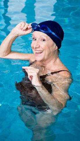 Old woman swimming in senior apartment pool