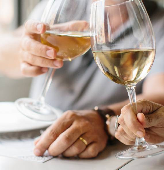 Senior couple enjoy drinking and clinking glass of wine to relax at senior living