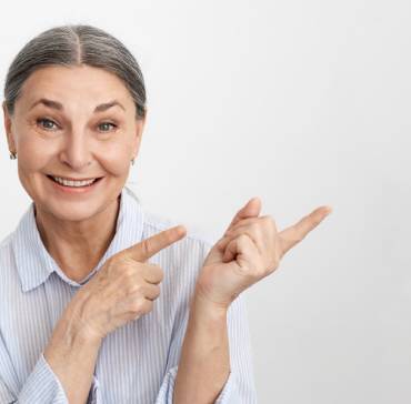 Happy smiling caregiver woman showing her two fingers